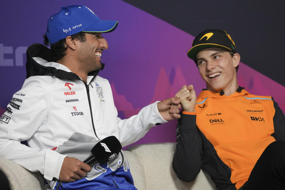 Daniel Ricciardo, left, of Australia driver of RB, the team previously known as AlphaTauri and McLaren driver Oscar Piastri of Australia react during a press conference ahead of the Australian Formula One Grand Prix at Albert Park, Melbourne, Australia, Thursday, March 21, 2024. (AP Photo/Asanka Brendon Ratnayake)