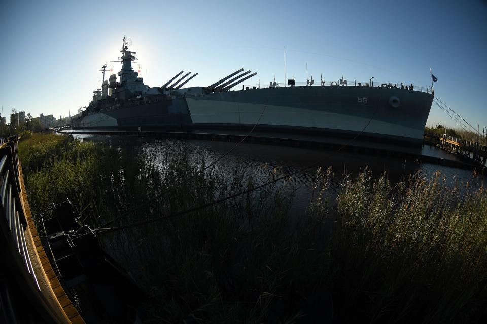 Flooding continues around the parking lot of the Battleship Friday, Oct. 13, 2023 in Wilmington. The Battleship North Carolina hopes to soon start a project, dubbed "Living with Water," which could help the Wilmington site along the Cape Fear River deal with flooding.