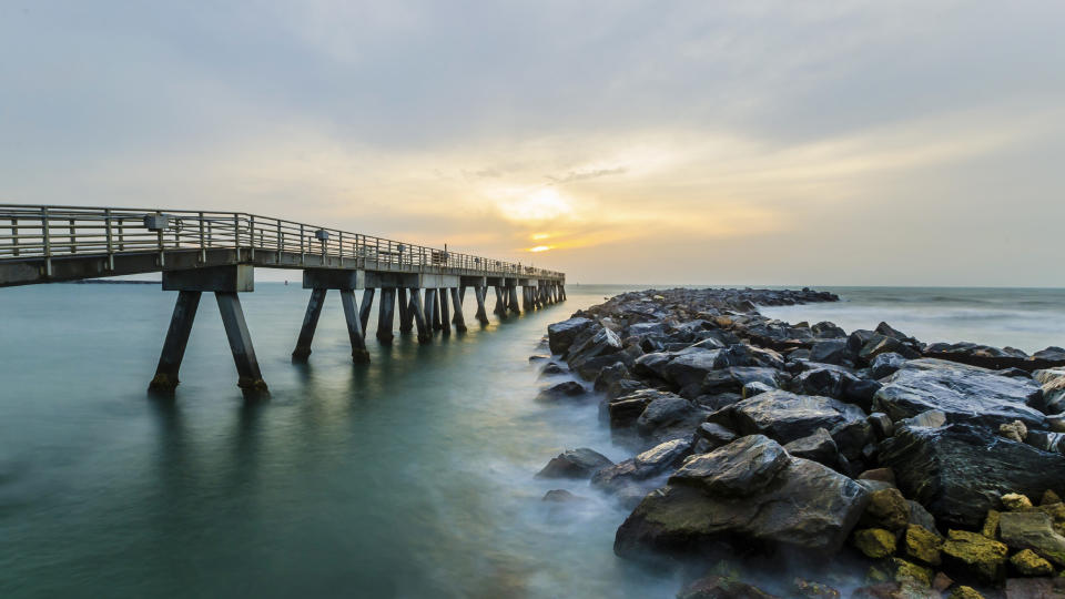 A fishing pier extends into the ocean in Jetty Park