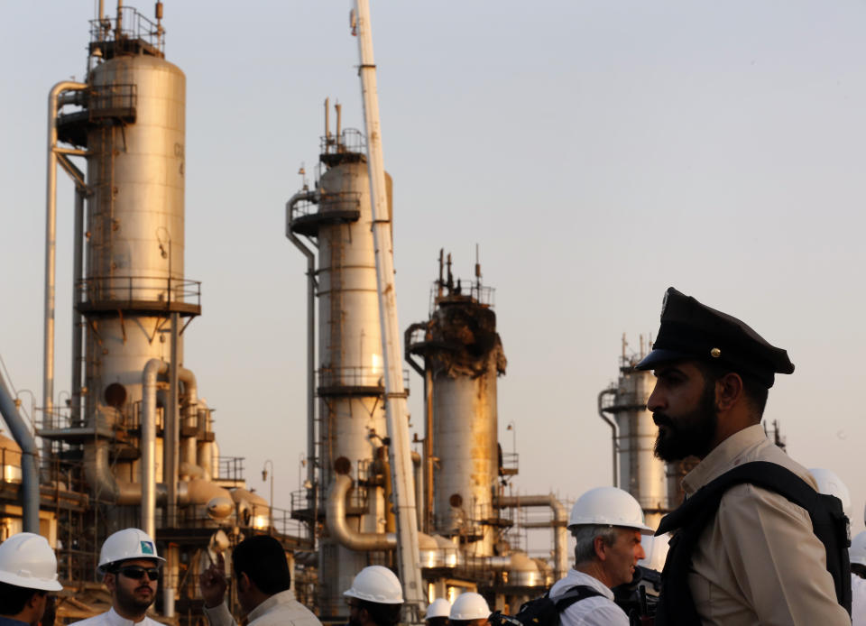 During a trip organized by Saudi information ministry, a security guarder stands alert in front of Aramco's oil processing facility after the recent Sept. 14 attack on Aramco's oil processing facility in Abqaiq, near Dammam in the Kingdom's Eastern Province, Friday, Sept. 20, 2019. Saudi Arabia allowed journalists access Friday to the site of a missile-and-drone attack on a facility at the heart of the kingdom's oil industry, an assault that disrupted global energy supplies and further raised tensions between the U.S. and Iran. (AP Photo/Amr Nabil)