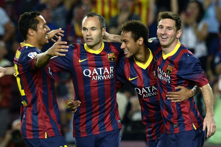 Picture taken on September 24, 2013 shows (R-L) Barcelona forwards Lionel Messi and Neymar da Silva Santos, midfielder Andres Iniesta and defender Adriano during a game against Real Sociedad at the Camp Nou stadium in Barcelona