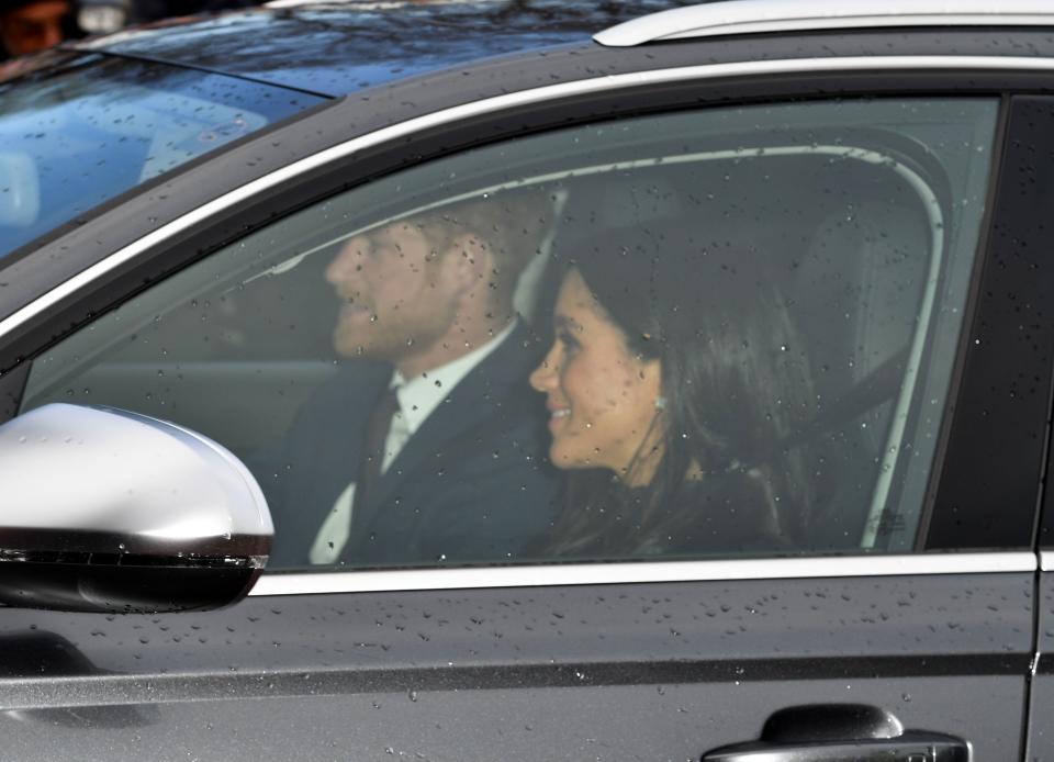 <p>The Duke and Duchess of Sussex smile as they drive to lunch [Photo: Rex] </p>