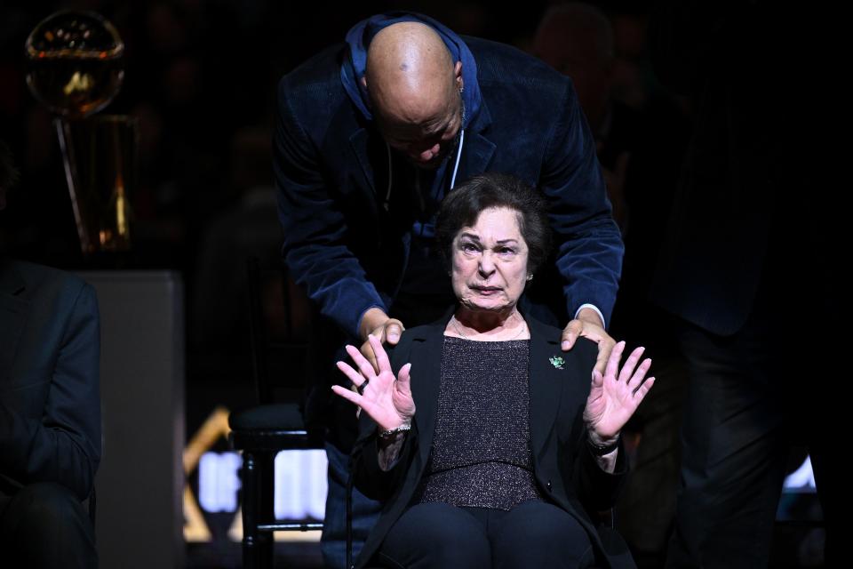 Thelma Krause is comforted by former Bulls player Ron Harper after Bulls fans booed Jerry Krause, her late husband, during the team's Ring of Honor celebration.