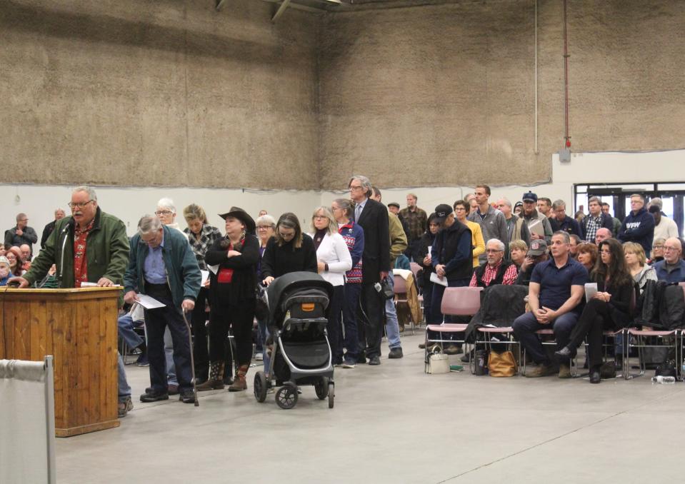 A long line of attendees at Tuesday's Cascade County Commission meeting ques up to present comments to commissioners