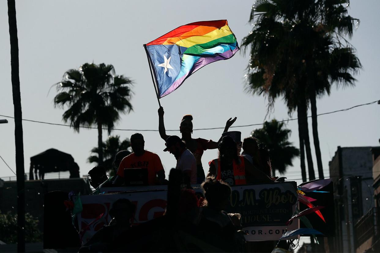 Revelers celebrate on 7th Avenue during the Tampa Pride Parade in the Ybor City neighborhood on March 26, 2022 in Tampa, Florida. The Tampa Pride was held in the wake of the passage of Florida's controversial "Don't Say Gay" Bill.