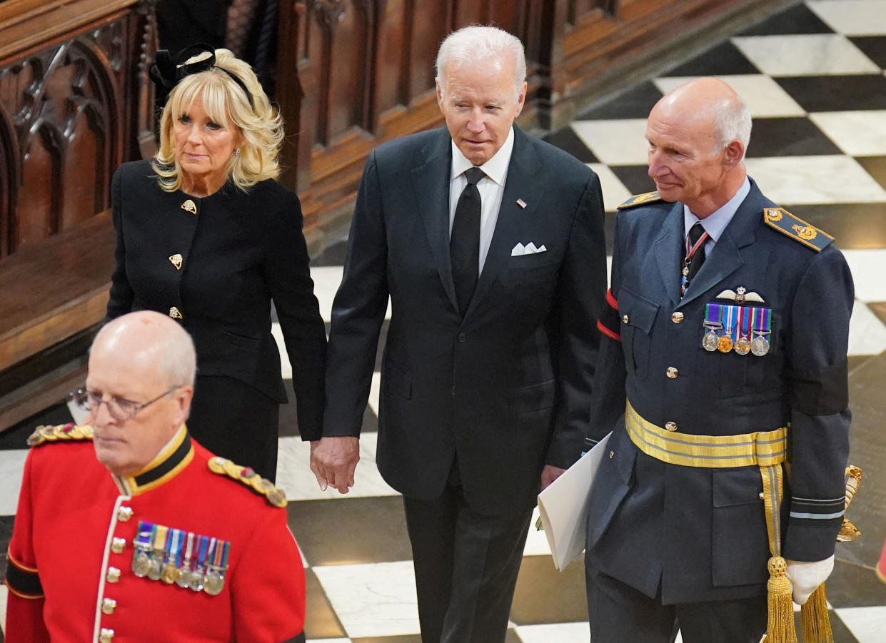 U.S. President Joe Biden and First Lady Jill Biden hold hands as they make their way to their seats for the service at Westminster Abbey. (Photo: Reuters) 