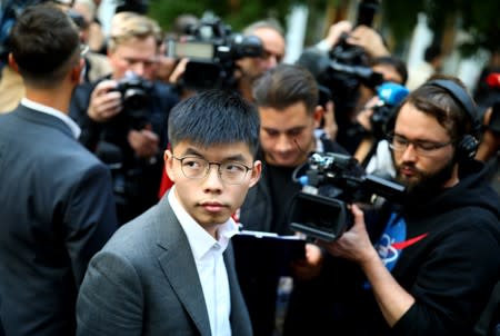 Hong Kong's pro-democracy activist Joshua Wong speaks with the media after a news conference in Berlin