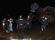 Lexington Police remove stop signs before University of Kentucky fans and students took to the street after University of Connecticut defeated Kentucky in the NCAA Men's National Basketball Championship near the university campus in Lexington, Kentucky, April 7, 2014. REUTERS/John Sommers II (UNITED STATES - Tags: SPORT BASKETBALL CIVIL UNREST)