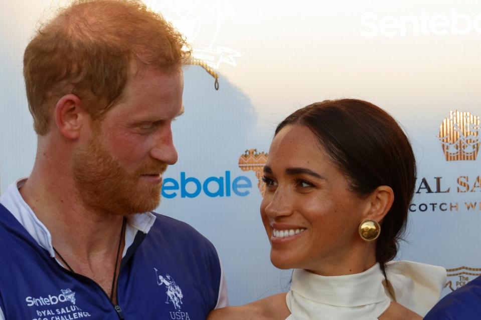 Britain’s Prince Harry and Meghan, Duchess of Sussex, look at each other as they attend the Royal Salute Polo Challenge. REUTERS