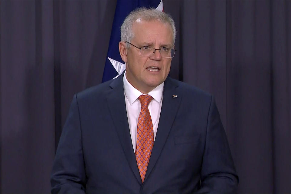 In this image made from video, Australian Prime Minister Scott Morrison speaks during a news conference in Canberra, Australia, Thursday, April 8, 2021. Australia on Thursday become the latest country to restrict use of the AstraZeneca vaccine by recommending that it not be given to people under age 50. (SBS via AP)