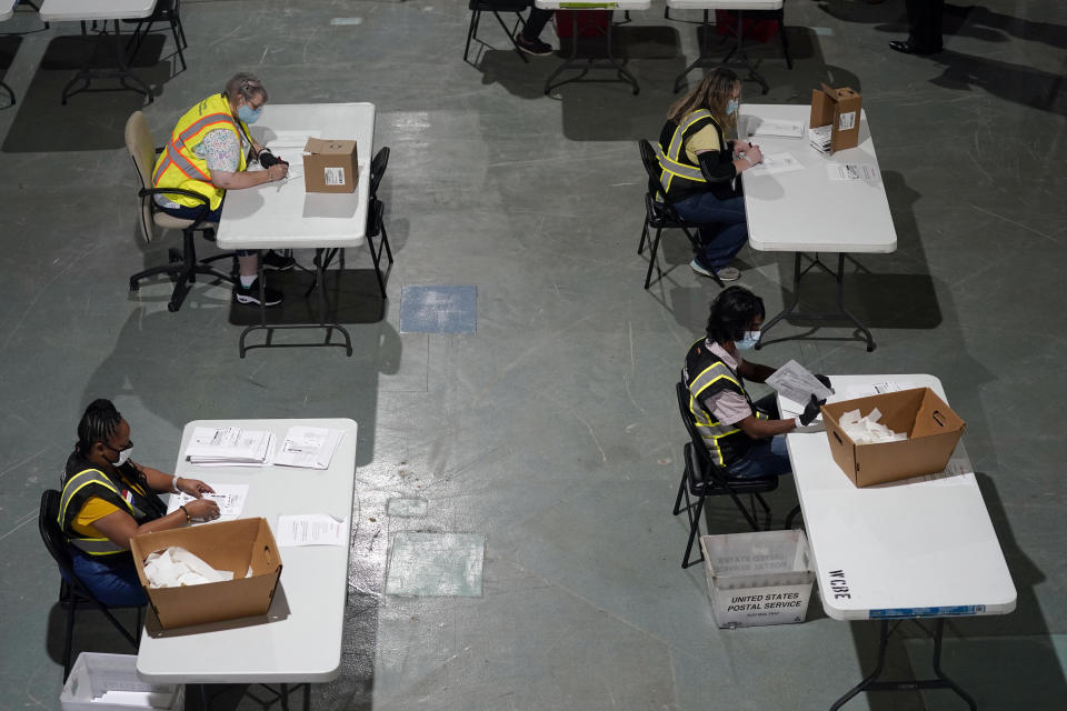 FILE - In this Thursday, Sept. 3, 2020 file photo, workers prepare absentee ballots for mailing at the Wake County Board of Elections in Raleigh, N.C. Black voters are among the least likely to vote by mail nationally, but there are early signs they are changing their behavior as the shadow of the coronavirus hangs over the presidential race. The evidence is clearest in North Carolina, the first state in the nation to send out mail ballots and where voting has been underway for almost three weeks. (AP Photo/Gerry Broome, File)