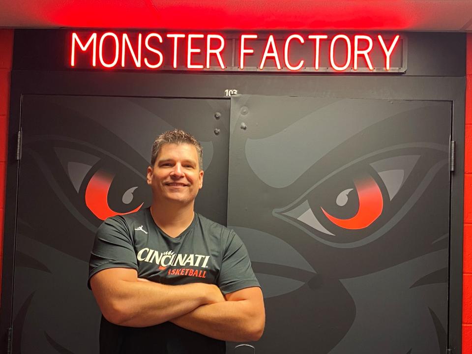 UC's Associate AD/Sports Performance Mike Rehfeldt stands outside of the door of the "Monster Factory" where UC's men's basketball team gets their grunt work done.