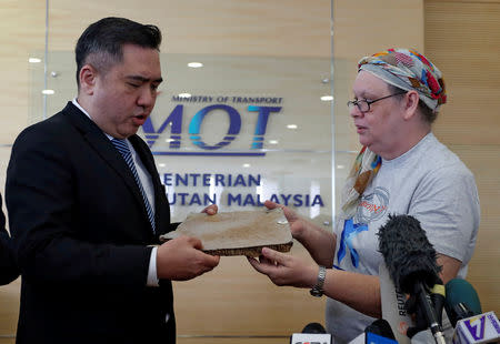 Jacquita Gonzales, the wife of in-flight supervisor Patrick Francis Gomes, who was onboard the missing Malaysia Airlines MH370, hands over debris believed to belong to MH370 to Malaysia's Transport Minister Anthony Loke Siew Fook in Putrajaya, Malaysia November 30, 2018. REUTERS/Lai Seng Sin