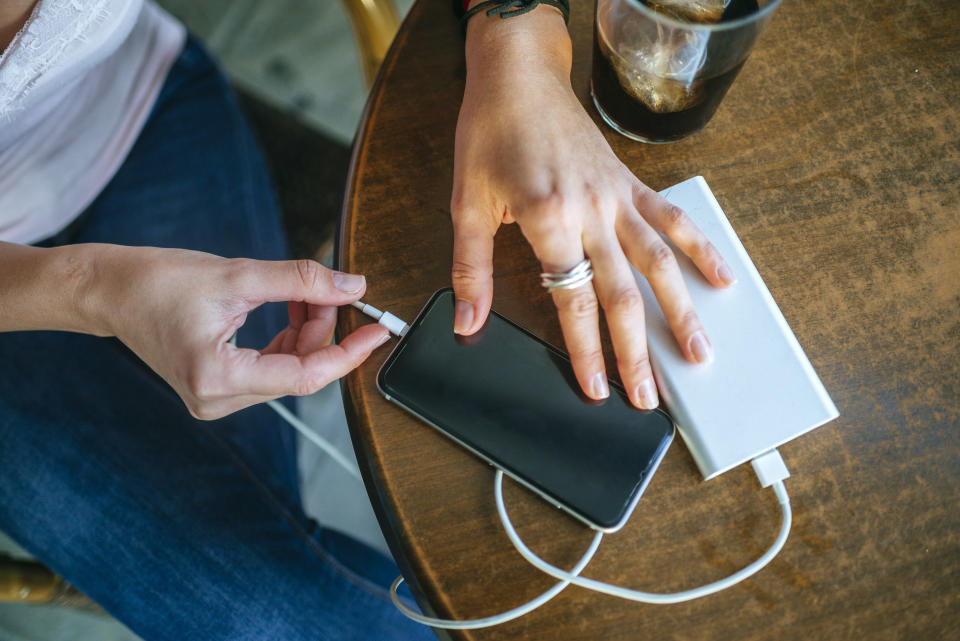 a smartphone plugged into an external charger