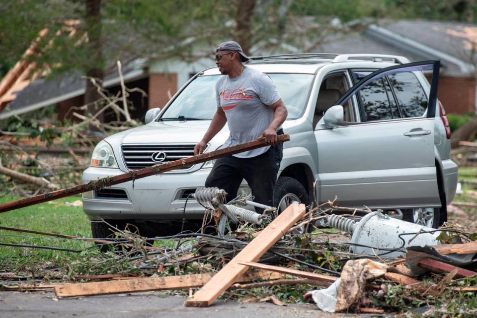 A resident clears the way for his car in Moss Point on Tuesday, June 20, 2023, after a tornado tore through the town on Monday.