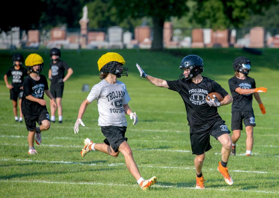 Elmwood/Brimfield players run offensive plays on the official first day of high school football practice Monday, Aug. 7, 2023 at Elmwood High School.