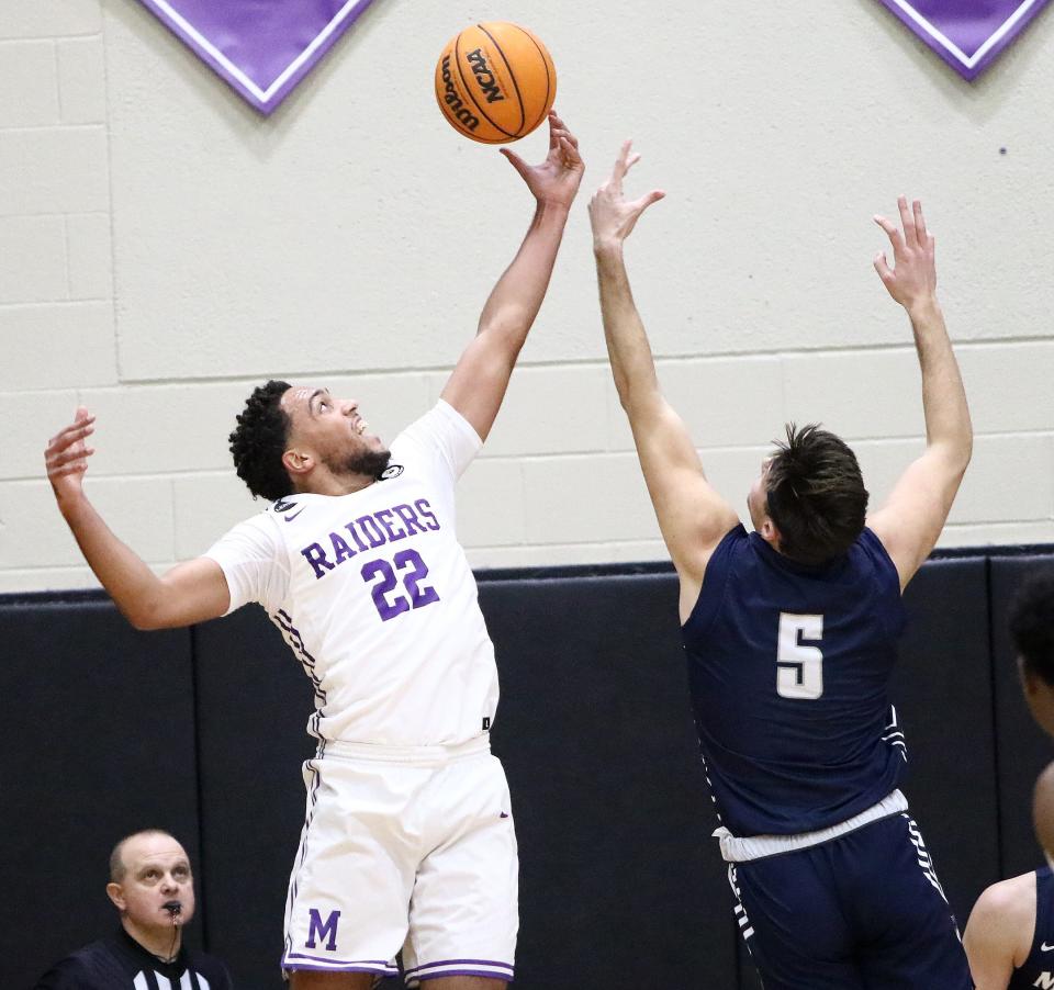 Mount Union's Christian Parker, left, and Marietta's Frank Waganfeald, right, go for a rebound during an Ohio Athletic Conference game at Mount Union on Wednesday, January 11, 2023.