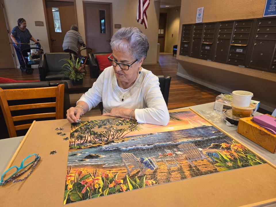 Felicitas Guerra puts together a puzzle at Casa Pedro Ruíz's common dining area after residents enjoyed a chef-cooked meal on July 24, 2024.