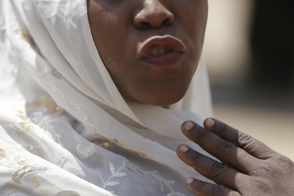 In this photo taken on Tuesday, Feb. 19, 2019, Maria Saleh a woman who says she was assaulted and displaced by Islamist extremist is photographed at Malkohi camp in Yola, Nigeria. Maria is from the town of Madagali in Adamawa, has a child by a Boko Haram fighter who assaulted and then enslaved her for months following a 2014 attack that killed her husband. Two of her children were taken by militants. (AP Photo/ Sunday Alamba)