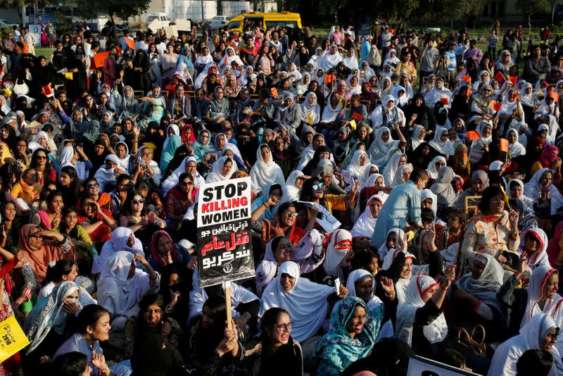 FILE PHOTO: People hold signs and chant slogans as they take part in an Aurat March, or Women's March in Karachi