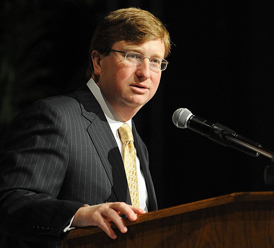 Shown speaking is Republican Gov. Tate Reeves. By Monday night, Reeves had vetoed several bills.