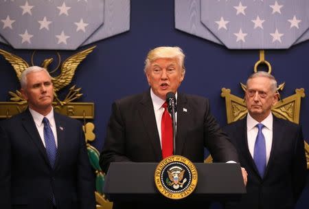 U.S. President Donald Trump (C) dellivers remarks after attending a swearing-in ceremony for Defense Secretary James Mattis (R) with Vice President Mike Pence at the Pentagon in Washington, U.S., January 27, 2017. REUTERS/Carlos Barria