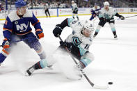 Seattle Kraken left wing Jared McCann (16) controls the puck in front of New York Islanders defenseman Ryan Pulock in the third period of an NHL hockey game Wednesday, Feb. 2, 2022, in Elmont, N.Y. The Kraken won 3-0. (AP Photo/Adam Hunger)