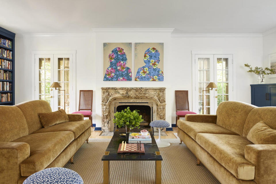 A pair of velvet-clad sofa anchor a living room brimming with lively accents