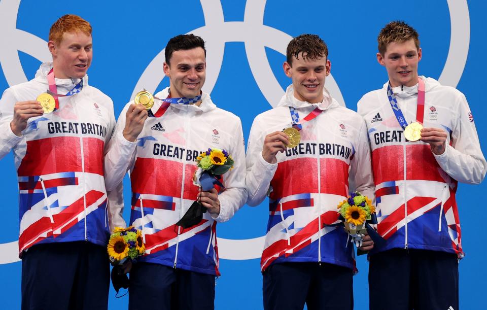 Tokyo 2020 Olympics - Swimming - Men's 4 x 200m Freestyle Relay - Final - Tokyo Aquatics Centre - Tokyo, Japan - July 28, 2021.Tom Dean of Britain, James Guy of Britain, Matthew Richards of Britain and Duncan Scoott of Britain pose on the podium with their gold medal REUTERS/Marko Djurica