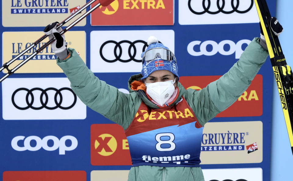 FILE - Norway's Heidi Weng celebrates on the podium after winning the women's Mass Start Free 10km event at the Tour de Ski in Val di Fiemme, Trento, Italy, on Jan. 4, 2022. Two members of Norway’s women’s cross-country team, Heidi Weng and Anne Kjersti Kalvaa, have tested positive for the coronavirus ahead of next month's Beijing Olympics. They contracted COVID-19 at a training camp in the Italian Alpine resort of Seiser Alm and are now isolating. (AP Photo/Giovanni Auletta, File)