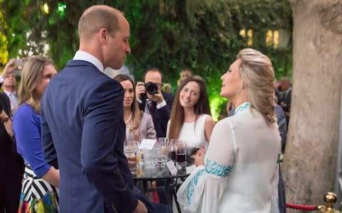 The Duke of Cambridge speaks to Alia Twal, the first woman pilot on Royal Jordanian Airways, as he attends the Queen's Birthday Party at UK Ambassador's residence in Amman - Credit: Arthur Edwards/PA