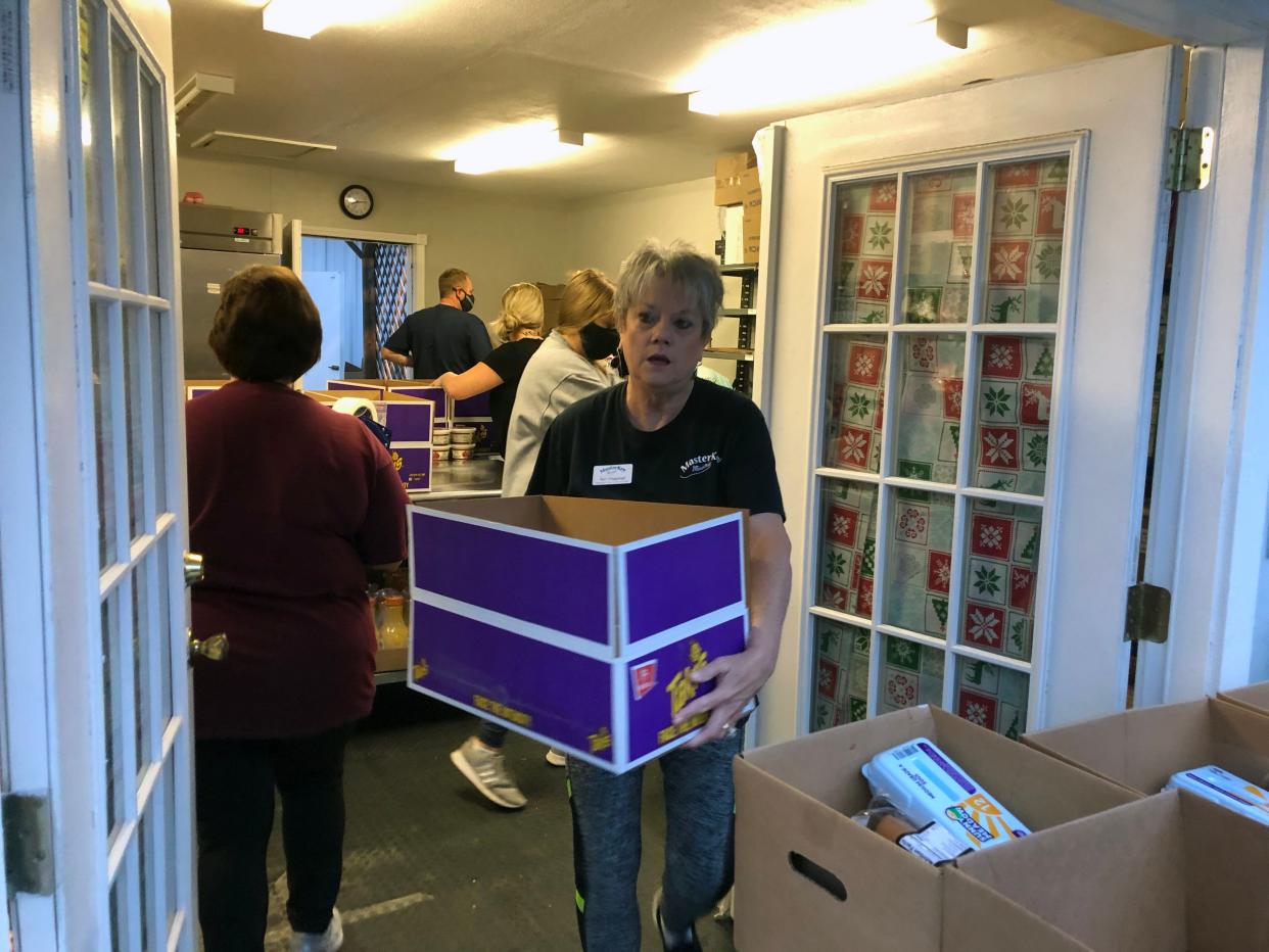 Terri Chapman with MasterKey ministries carries boxes at the multi-organization Thanksgiving Dinner giveaway in this 2020 photo.