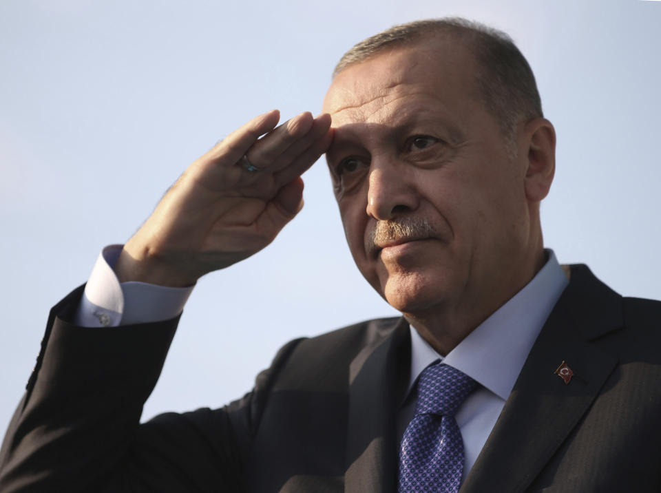 Turkish President Recep Tayyip Erdogan gives a military style salute toward his supporters during a rally in Kayseri, Turkey, Saturday, Oct. 19, 2019. Turkish Red Crescent says it has delivered humanitarian aid for 2000 people in Syrian town of Ras Al-Ayn and says it also provided aid to Tal Abyad and will continue to do so in areas cleared from Syrian Kurdish fighters.(Presidential Press Service via AP, Pool )