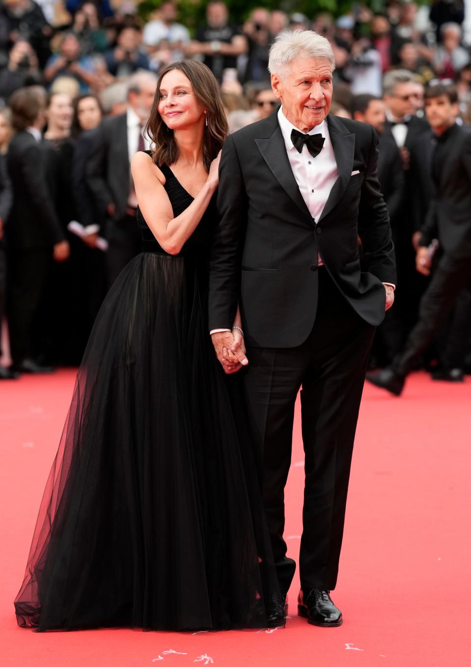Calista Flockhart and Harrison Ford pose for photographers at Cannes.