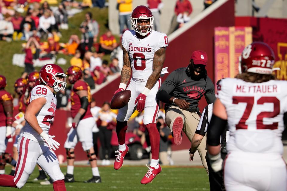OU defensive back Woodi Washington (0) celebrates with teammates after intercepting a pass during the first half of a 27-13 win against Iowa State on Oct. 29 at Jack Trice Stadium in Ames, Iowa.
