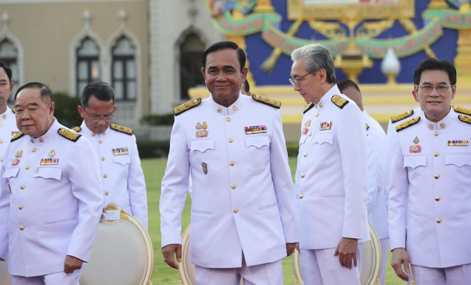 Thailand's Prime Minister Prayuth Chan-ocha smiles after a group photo with his cabinet members at the government house in Bangkok Tuesday, July 16, 2019. Prayuth on Tuesday led his 36 cabinet members to take their oath in front of Thailand's King Maha Vajiralongkorn. (AP Photo/Sakchai Lalit)