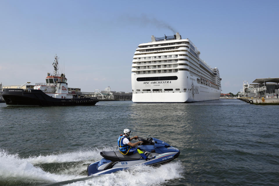 The the 92,409-ton, 16-deck MSC Orchestra cruise ship exits the lagoon as it leaves Venice, Italy, Saturday, June 5, 2021. The first cruise ship leaving Venice since the pandemic is set to depart Saturday amid protests by activists demanding that the enormous ships be permanently rerouted out the fragile lagoon, especially Giudecca Canal through the city's historic center, due to environmental and safety risks. (AP Photo/Antonio Calanni)