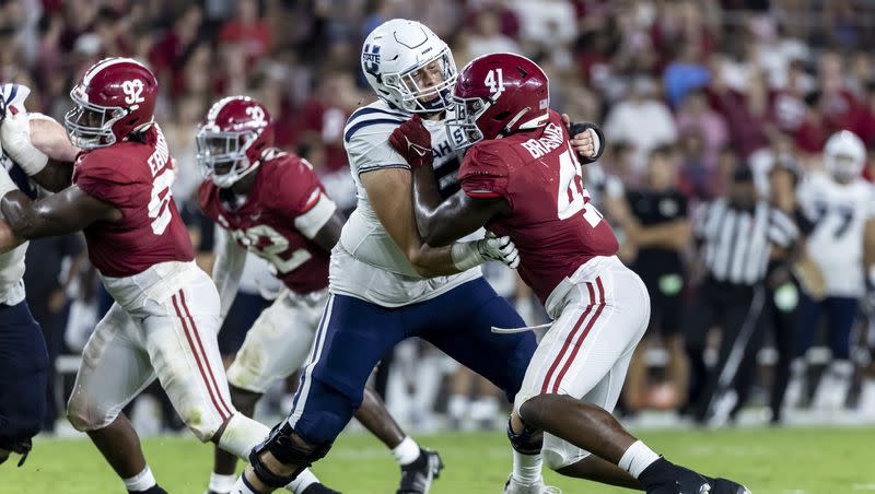 Utah State offensive lineman Cole Motes (56) battles Alabama linebacker Chris Braswell (41) during the second half of an NCAA college football game, Saturday, Sept. 3, 2022, in Tuscaloosa, Ala. 