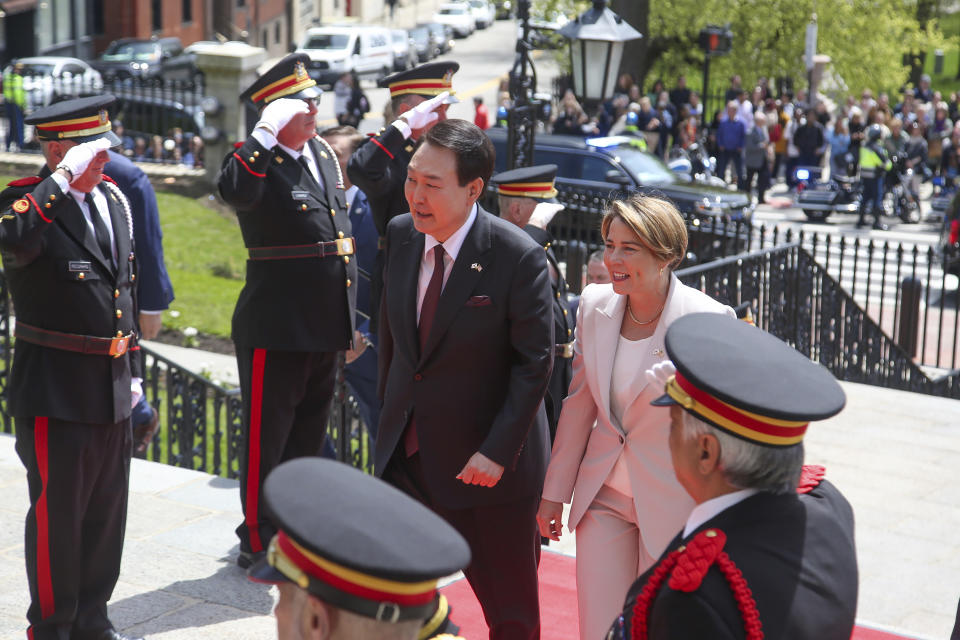 Mass. Governor Maura Healey and South Korea's President Yoon Suk Yeol approach the Massachusetts Statehouse, Friday, April 28, 2023, in Boston, Mass. Yoon stopped at the State House ahead of a talk at Harvard University as he wrapped up a state visit to the United States. (AP Photo/Reba Saldanha)