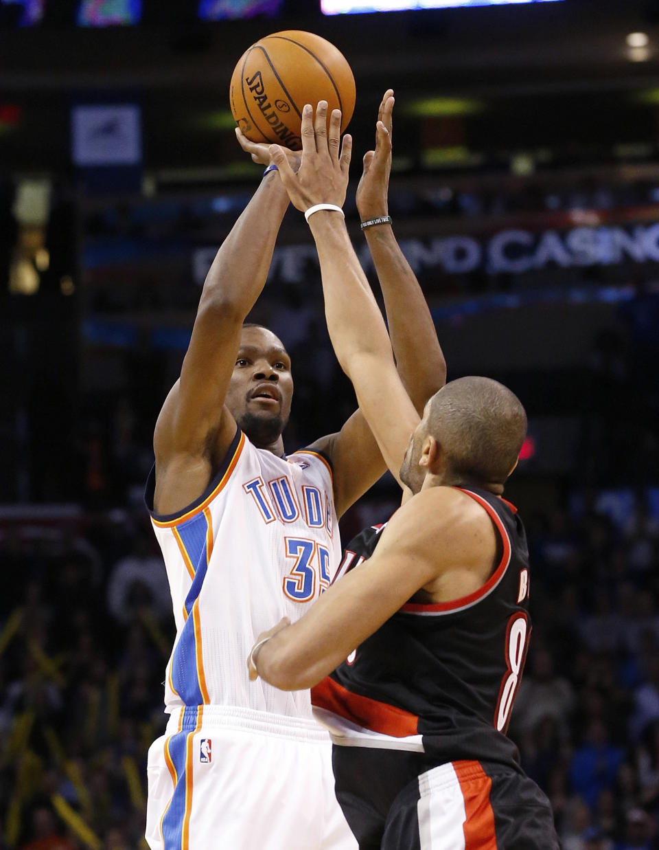 Oklahoma City Thunder forward Kevin Durant (35) shoots over Portland Trail Blazers forward Nicolas Batum, right, in the fourth quarter of an NBA basketball game in Oklahoma City, Tuesday, Jan. 21, 2014. Oklahoma City won 105-97. (AP Photo/Sue Ogrocki)