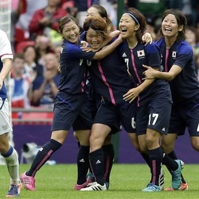 Japan's Mizuho Sakaguchi, center, celebrates her goal with teammates Nahomi Kawasumi, left, Saki Kumagai, right, Yuki Ogimi and Saki Kumagai during thier women's soccer semifinal match against France at Wembley Stadium during the 2012 Summer Olympics, Monday, Aug. 6, 2012, in London. (AP Photo/Luca Bruno)