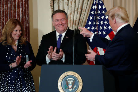 U.S. President Donald Trump participates in incoming Secretary of State Mike Pompeo's ceremonial swearing-in at the State Department in Washington, U.S. May 2, 2018. Also pictured is Pompeo's wife, Susan Pompeo. REUTERS/Jonathan Ernst