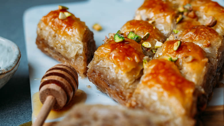 Baklava and honey on marble