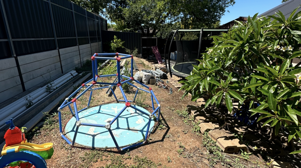 Children's toys in the half finished backyard. 