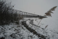 Hungary's border fence with Serbia is seen outside the village of Gyala, Serbia, Thursday, Jan. 13, 2022. Hungary's nationalist prime minister, Viktor Orban, is keen to use the threat of migrants at his country's southern border to give him an advantage in upcoming elections. But the scale of migration pressure claimed by Orban is drawn into question by statistics from neighboring Serbia and the European Union's border agency. (AP Photo/Bela Szandelszky)