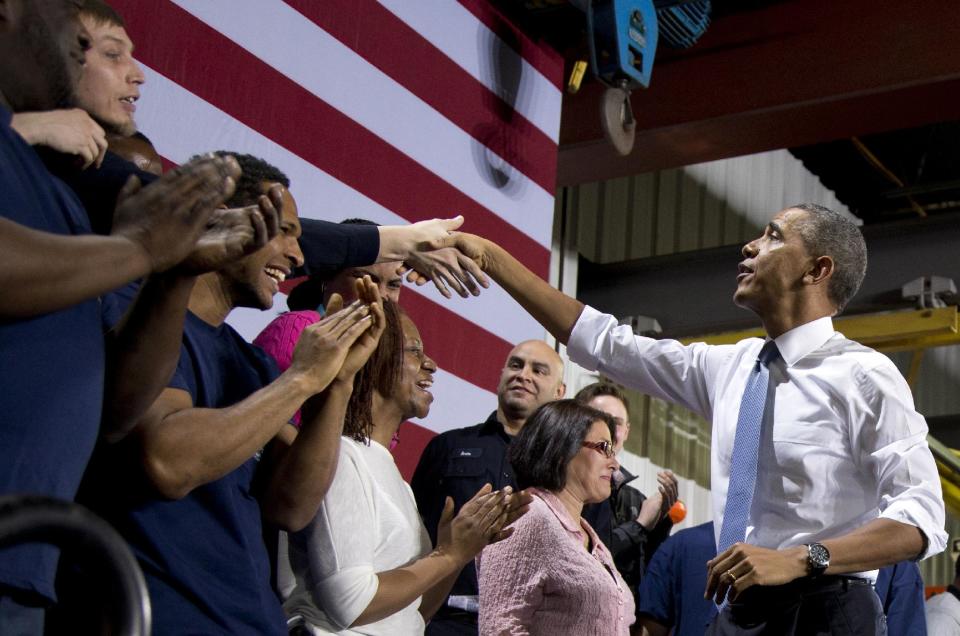 President Barack Obama greets people on stage after speaking at General Electric’s Waukesha Gas Engines facility, Thursday, Jan. 30, 2014, in Waukesha, Wis. This trip to Waukesha, Wis., is part of a four-stop tour President Barack Obama is making to expand on themes from his State of the Union address. (AP Photo)