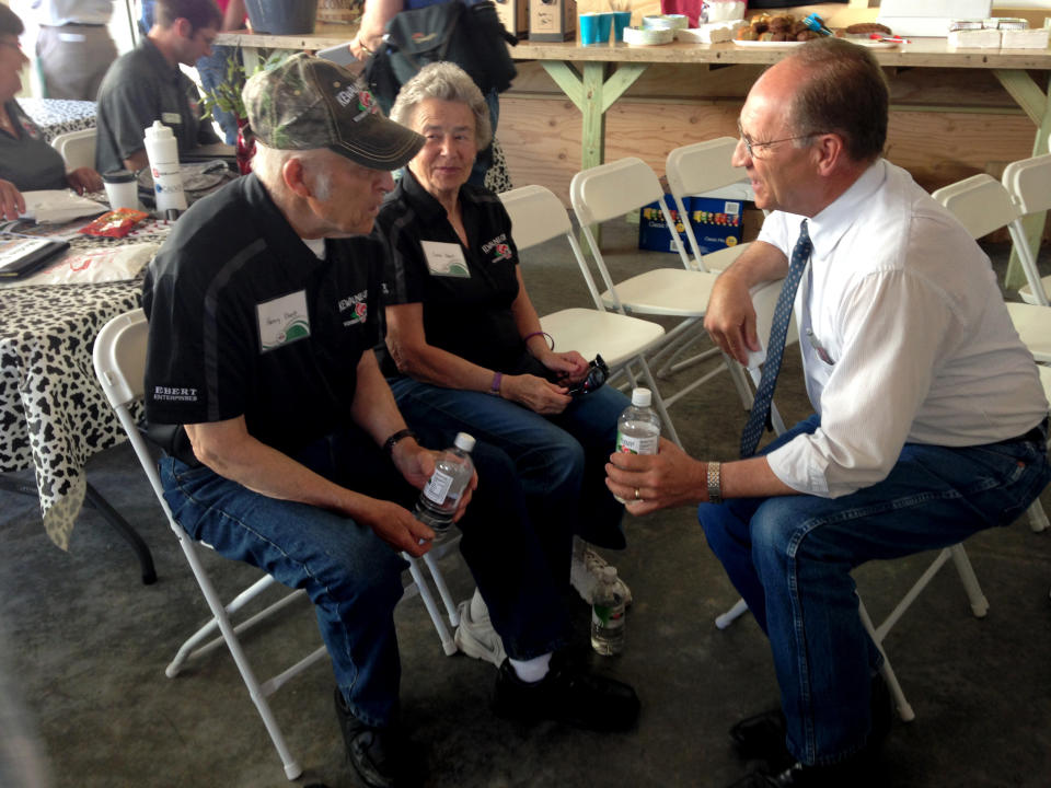 Then-Wisconsin Agriculture Secretary Ben Brancel meets with Henry and Carol Ebert during Farm Technology Days in Algoma, Wisconsin, June 6, 2017. Brancel, who retired in August, says the United States should change immigration law to accommodate the growing number of immigrants working in the dairy industry. (Photo: Dept of Agriculture Trade and Consumer Protection)