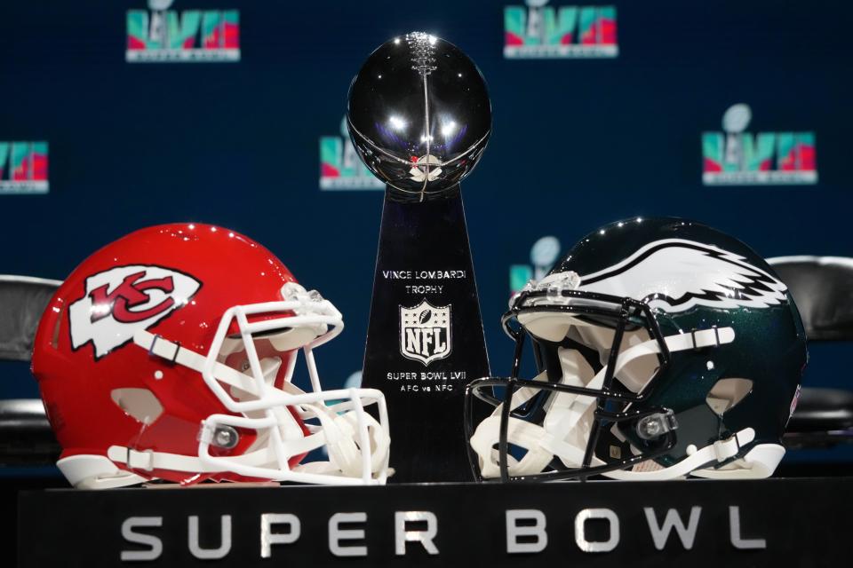 Kansas City Chiefs and Philadelphia Eagles helmets sit next to the Vince Lombardi Trophy.