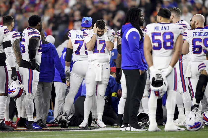 Buffalo Bills quarterback Josh Allen (17) pauses as Damar Hamlin is examined by medical staff during the first half of an NFL football game against the Cincinnati Bengals, Monday, Jan. 2, 2023, in Cincinnati. (AP Photo/Emilee Chinn)