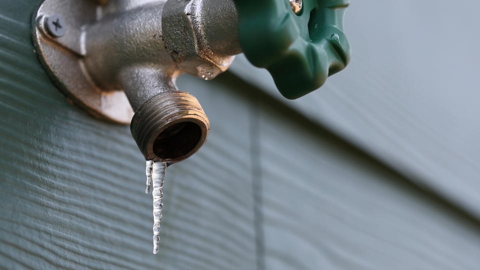 frozen exterior faucet with icicles hanging from the end